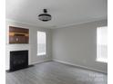 Living room featuring wood flooring, a fireplace, and natural light at 10615 Elm Bend Dr, Charlotte, NC 28273