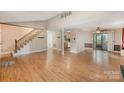 Open-concept living room featuring hardwood floors and views of the staircase and adjacent kitchen at 110 Hidden Valley St, Cherryville, NC 28021
