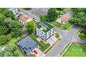 Aerial view of a modern home with a green roof and manicured lawn in a suburban neighborhood at 129 French St, Charlotte, NC 28216