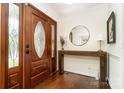Elegant entryway with hardwood floors, decorative glass front door, and a stylish wood console table at 139 Palaside Ne Dr, Concord, NC 28025