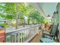 Cozy porch featuring classic wooden rocking chairs and neighborhood views, perfect for relaxing evenings at 14533 Holly Springs Dr, Huntersville, NC 28078