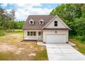 A lovely home with white siding, a brown roof, an attached garage, and a spacious concrete driveway at 1471 Marshbrooke Ln, Catawba, NC 28609