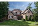 Stately brick home with manicured lawn, mature trees, and a charming walkway at 1500 Lookout Cir, Waxhaw, NC 28173