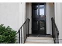 Close-up of a classic black front door with glass panes and metal hardware, leading into the home at 153 Perrin Pl, Charlotte, NC 28207