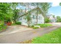 Exterior showcasing home's side, driveway, and lush surrounding greenery at 153 S Center St, Taylorsville, NC 28681