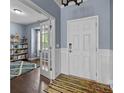 Inviting foyer with hardwood floors, white wainscoting, and an open view to a study/office space at 1569 Shannon Falls Dr, Fort Mill, SC 29715