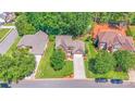 Aerial view of beautiful home with manicured lawn, mature trees, and a well-maintained neighborhood at 15811 Burlingame Dr, Huntersville, NC 28078