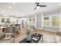 Bright living area with wood floors, lots of windows, and adjoined to modern kitchen at 2003 Ashley Rd # B, Charlotte, NC 28208