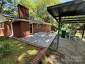 Outdoor patio area with table and chairs, next to covered structure at 211 S Slack St, Albemarle, NC 28001