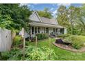 Landscaped front yard featuring flowers, and a covered front porch at 300 S Hudson Ave, Spencer, NC 28159