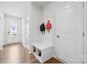 Bright foyer featuring coat rack with bench, storage, and attractive wood-look flooring at 3115 Hutton Gardens Ln, Charlotte, NC 28269