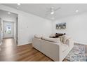 Inviting living room with modern ceiling fan, wood-look floors, and neutral color palette at 3115 Hutton Gardens Ln, Charlotte, NC 28269