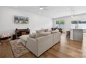 Open-concept living area with hardwood floors, neutral paint, and a view of the dining and kitchen at 3115 Hutton Gardens Ln, Charlotte, NC 28269