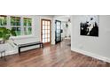 Inviting foyer featuring hardwood floors, a bench, natural light, and entrances to other rooms at 316 Wade Hampton Dr, Matthews, NC 28104