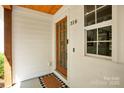 Close-up of the front door showcasing the address, a paneled glass door, and clean, white trim at 316 Wade Hampton Dr, Matthews, NC 28104