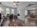 Bright home office featuring hardwood floors, a ceiling fan, a large desk, and lots of natural light at 322 Ethan Ln, Rock Hill, SC 29732