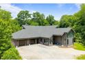 Wide view of modern home with a three-car garage, striking architecture, and gravel driveway at 3304 Mar Vista Cir, Charlotte, NC 28209