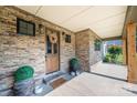 Inviting front porch features stone accents, a wooden front door, and stylish decor at 3741 9Th Street Ne Ct, Hickory, NC 28601