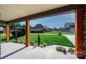 Covered front porch with wooden support beams and a view of the beautifully landscaped front yard at 3741 9Th Street Ne Ct, Hickory, NC 28601