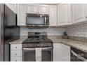 Modern kitchen with stainless steel appliances, granite countertops, and white subway tile backsplash at 4000 Garfield Ct, Waxhaw, NC 28173