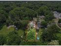 Aerial view of a home with a pool and a large, treed lot outlined in red to show the boundaries at 412 Dale Ave, Gastonia, NC 28052