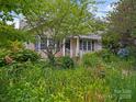 Charming home featuring a landscaped front yard and inviting entrance with dark shutters at 412 Dale Ave, Gastonia, NC 28052