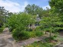 Charming home featuring a landscaped front yard and inviting entrance with dark shutters at 412 Dale Ave, Gastonia, NC 28052