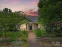 Charming home featuring a landscaped front yard and inviting entrance with dark shutters at 412 Dale Ave, Gastonia, NC 28052