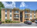 Well-maintained brick condo building with multiple balconies and parking at 4736 Hedgemore Dr, Charlotte, NC 28209