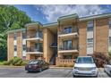 Attractive condo building with brick facade, multiple balconies, and ample parking at 4736 Hedgemore Dr, Charlotte, NC 28209
