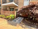 Inviting walkway with stone pavers and beautiful landscaping leads to the unit's brick-enclosed patio at 4736 Hedgemore Dr, Charlotte, NC 28209