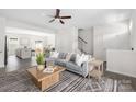 Bright living room with hardwood floors, plush sofa, and open floor plan at 5008 Patton Dr, Gastonia, NC 28056