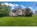 Expansive backyard featuring a screened porch and lush lawn, ideal for outdoor living and entertaining at 501 Preservation Dr, Fort Mill, SC 29715