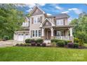 Lovely two-story home featuring a welcoming front porch and an attached two-car garage at 501 Preservation Dr, Fort Mill, SC 29715