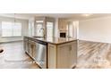 Bright kitchen boasts granite counters, an island with sink, stainless steel appliances, and an open floor plan at 5205 Raging Creek Dr # 122, Indian Trail, NC 28079