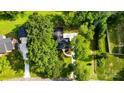 Aerial view of a landscaped property featuring a charming home, green lawn and driveway at 5811 Gettysburg Dr, Concord, NC 28027
