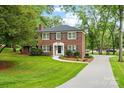Charming two-story brick home with a manicured lawn and classic black shutters and trim at 5811 Gettysburg Dr, Concord, NC 28027