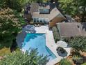 Backyard aerial view with a pool, patio area, and well-manicured landscaping at 629 Wingrave Dr, Charlotte, NC 28270