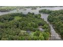 Aerial view of the property surrounded by lush trees and lake access at 8283 Long Island Rd, Catawba, NC 28609