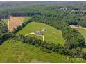 Stunning aerial view of an estate home on a large acreage with mature trees and a lush lawn at 830 John Rainey Rd, Salisbury, NC 28147