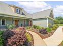 Charming front exterior highlighting the landscaped walkway, covered porch and beautiful curb appeal at 830 John Rainey Rd, Salisbury, NC 28147