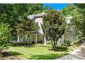 Inviting home with a covered porch, swing, mature trees and a well-maintained lawn at 833 Lemond Ln, Denver, NC 28037