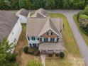 Aerial view of a two-story home with manicured lawn and landscaping in a suburban neighborhood at 10349 Alvarado Way, Charlotte, NC 28277