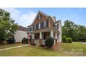 Charming two-story brick home with a welcoming front porch and a manicured lawn in a quiet neighborhood at 10349 Alvarado Way, Charlotte, NC 28277