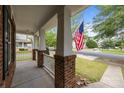 View from the porch of a two-story home with brick columns and white railings in a suburban neighborhood at 10349 Alvarado Way, Charlotte, NC 28277