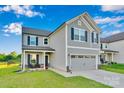 Charming two-story home with gray siding, a welcoming front porch, and a lush green lawn at 112 Aspire Cir, Wingate, NC 28174