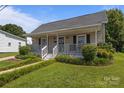 Quaint single-story home with a welcoming front porch and well-maintained landscaping at 113 Ervin St, Belmont, NC 28012