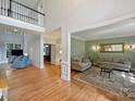 Bright living room with hardwood floors and neutral paint, perfect for relaxing or entertaining guests at 12644 Lahinch Ct, Charlotte, NC 28277