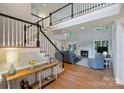 Open living room with a fireplace and many windows that offer natural light at 12644 Lahinch Ct, Charlotte, NC 28277