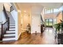 Grand foyer with hardwood floors, staircase, and high ceilings with natural light, creating a welcoming entrance at 14041 Mccord Rd, Huntersville, NC 28078